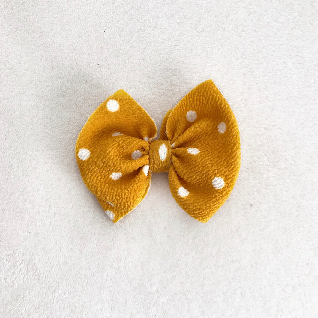 Mustard and white polka dot bow clip